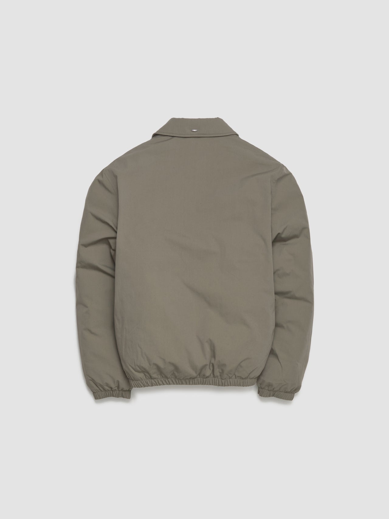 Green jacket on a light gray background