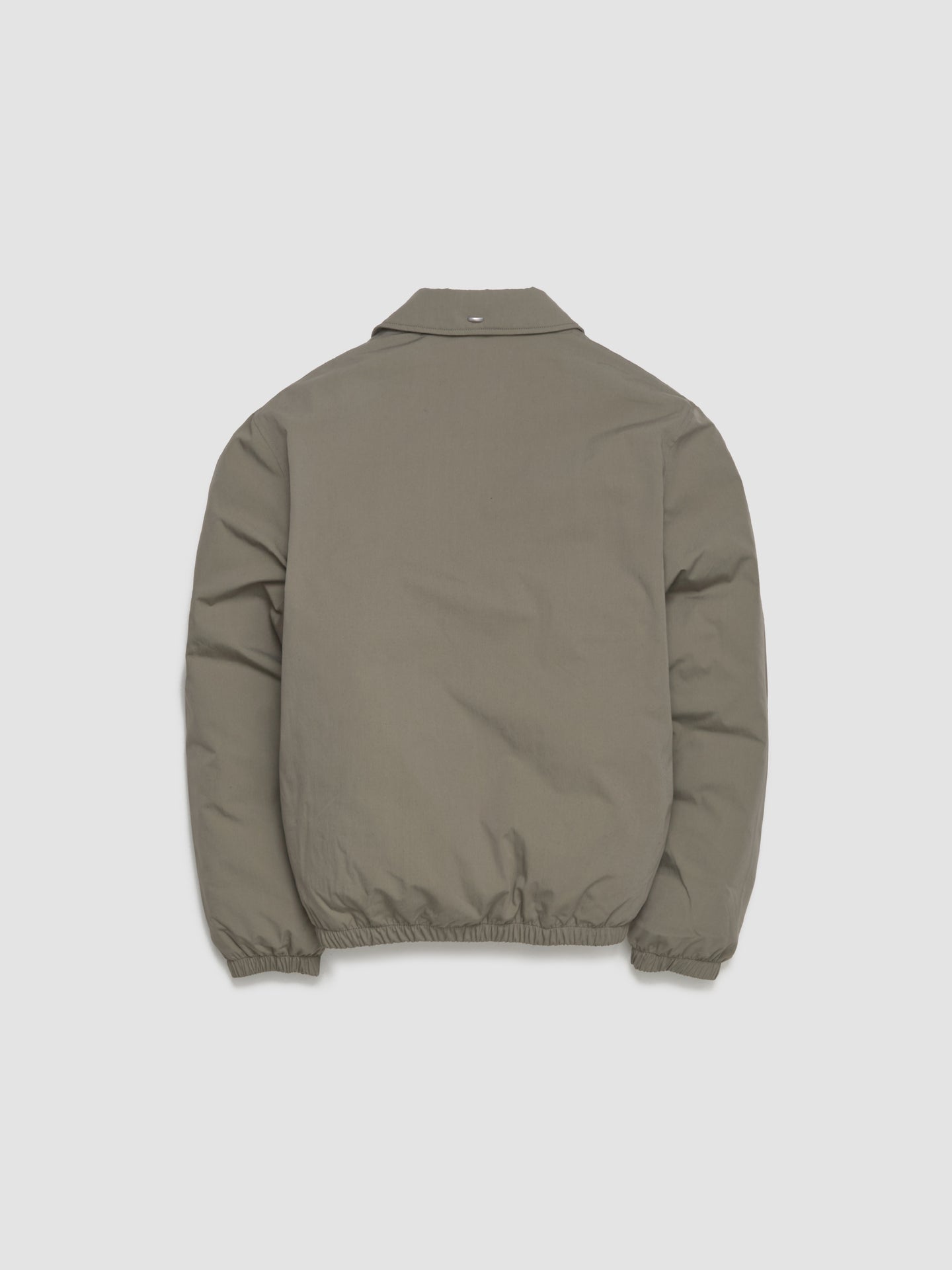 Green jacket on a light gray background