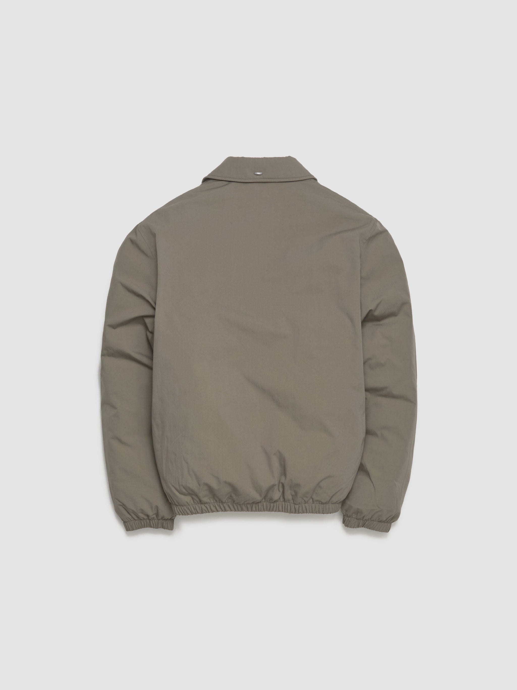 Green jacket on a light gray background