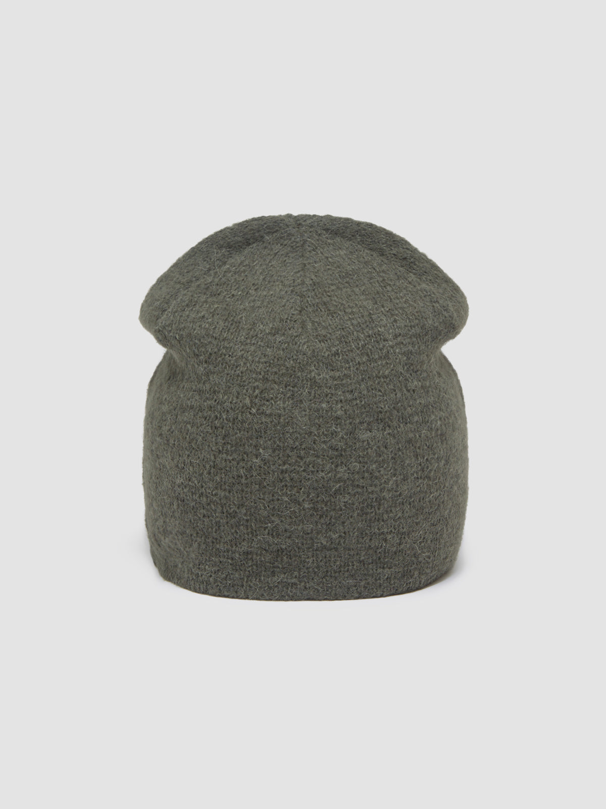 Green knit beanie on a light gray background