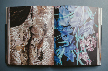 Open book showing two pages with textured patterns and floral designs.